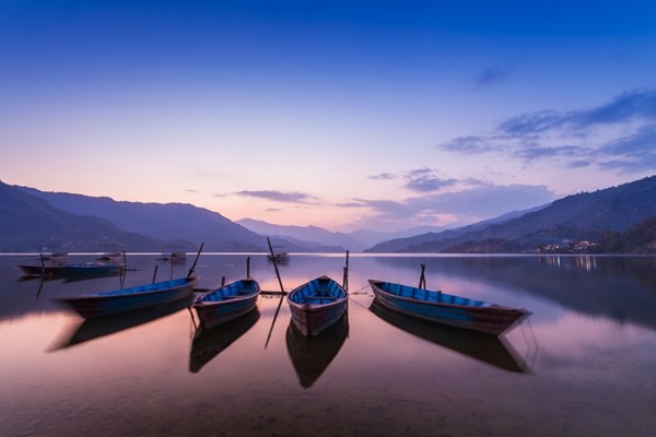 a beautiful and peaceful lake photo with some boats